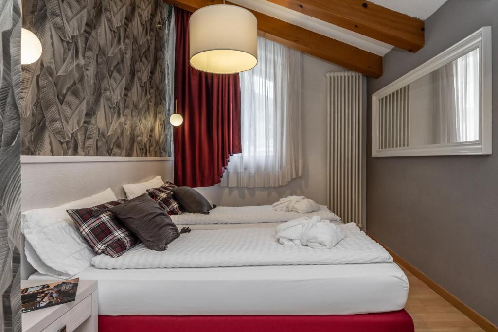 Postel nebo postele na pokoji v ubytování Hotel Folgarida