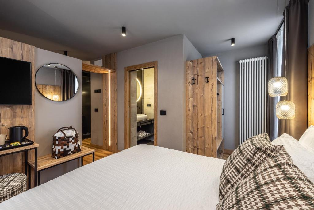 Postel nebo postele na pokoji v ubytování Hotel Folgarida