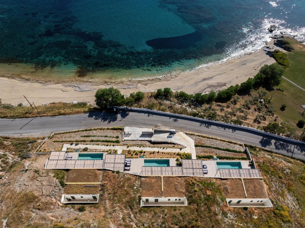 an aerial view of a resort with a beach at 'S CAVE VILLAS SEASIDE KARYSTOS in Karistos
