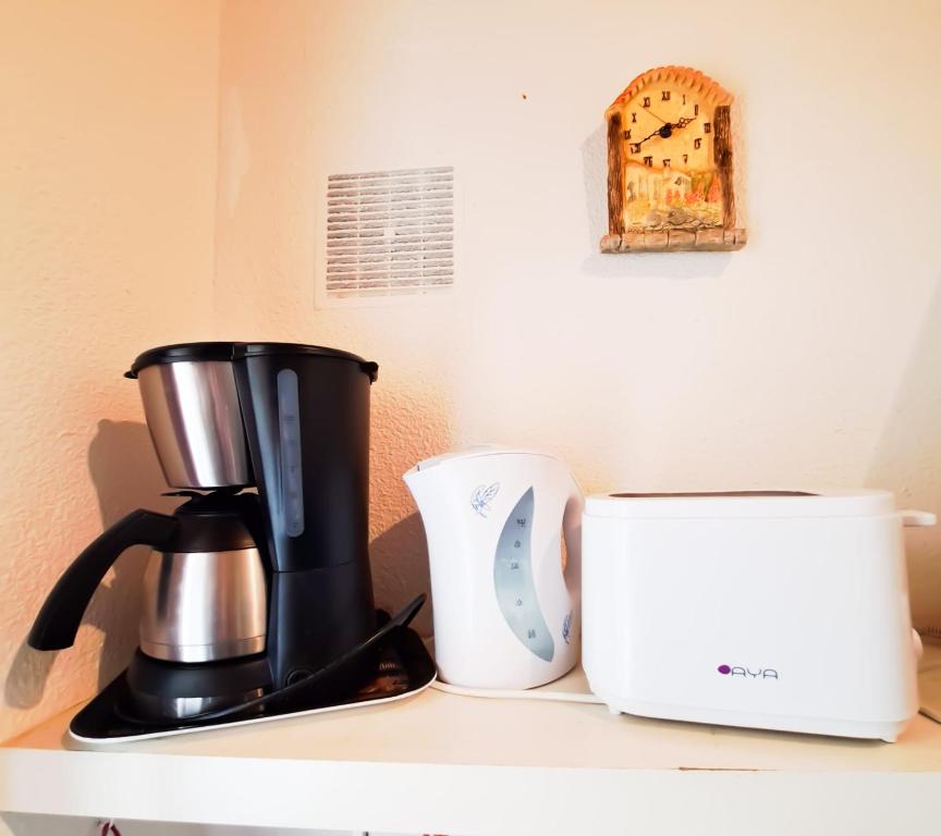 a coffee maker and a toaster on a counter at La Tiloé des dunes ~ T3 centre de la Palmyre in Les Mathes