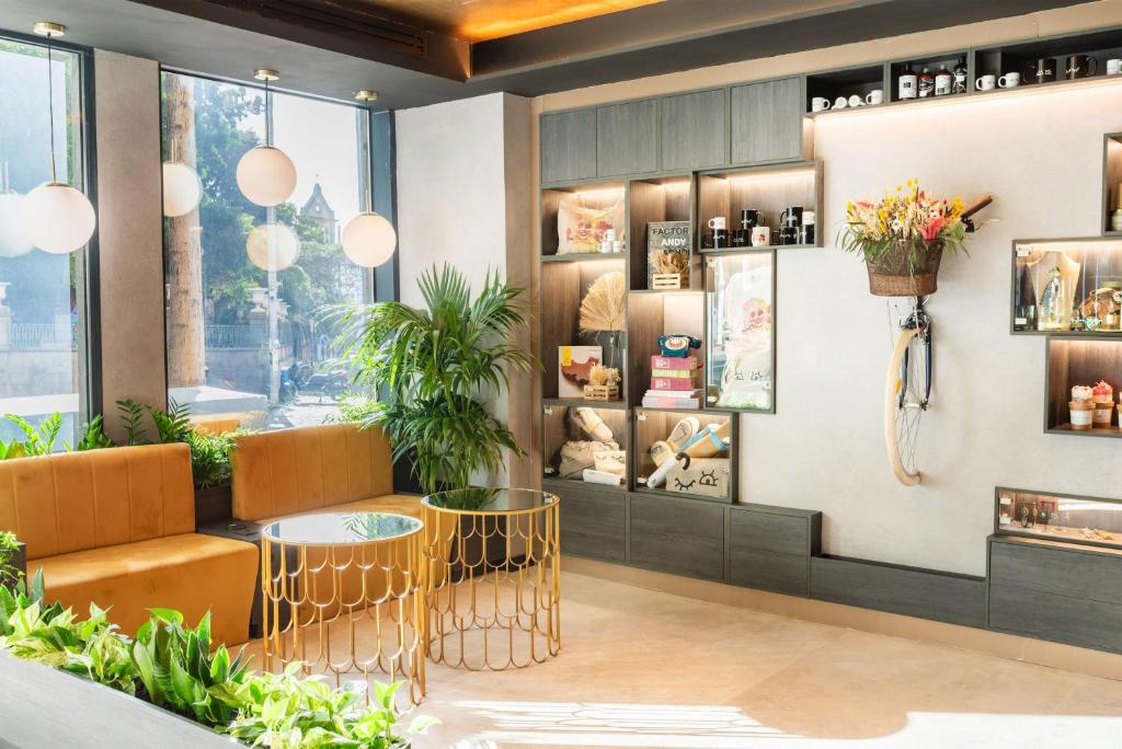 a restaurant with orange chairs and tables in a room at INNSiDE by Meliá Tenerife Santa Cruz in Santa Cruz de Tenerife