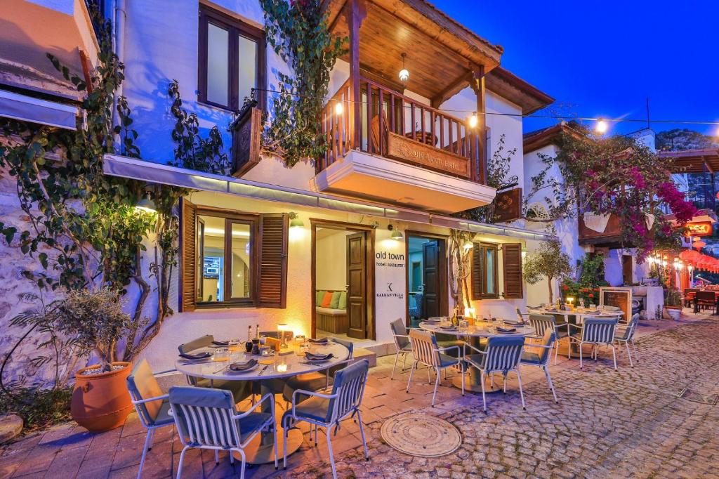 a patio with tables and chairs in front of a building at Old Town Hotel Kalkan in Kalkan