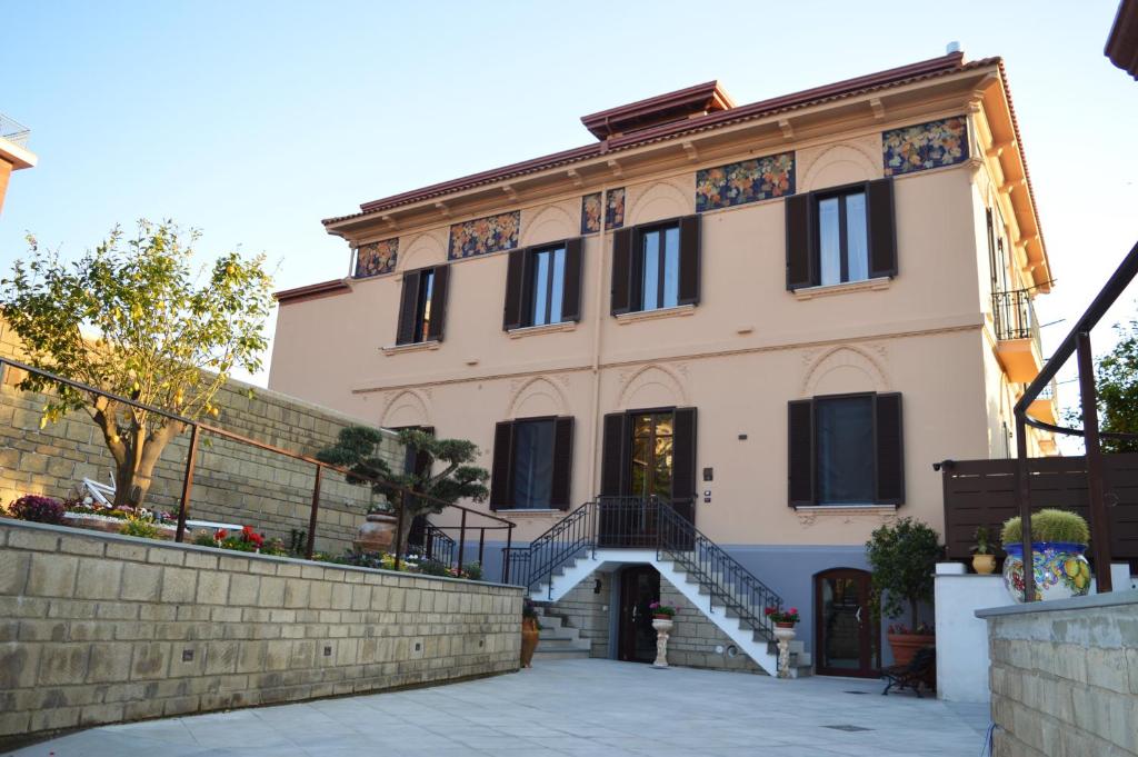 a large building with a staircase in front of it at VILLA AGOSTINO LUXURY B&b in Vico Equense