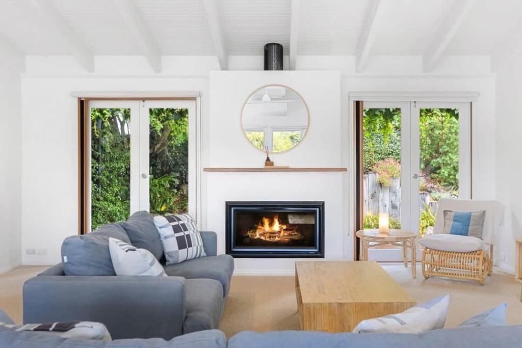 a living room with a couch and a fireplace at Bellarine Lake House Ocean Grove in Ocean Grove