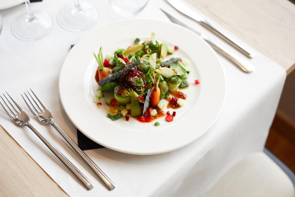 a white plate with a salad on a table at Inmood Aucanada 4 Sup in Port d'Alcudia