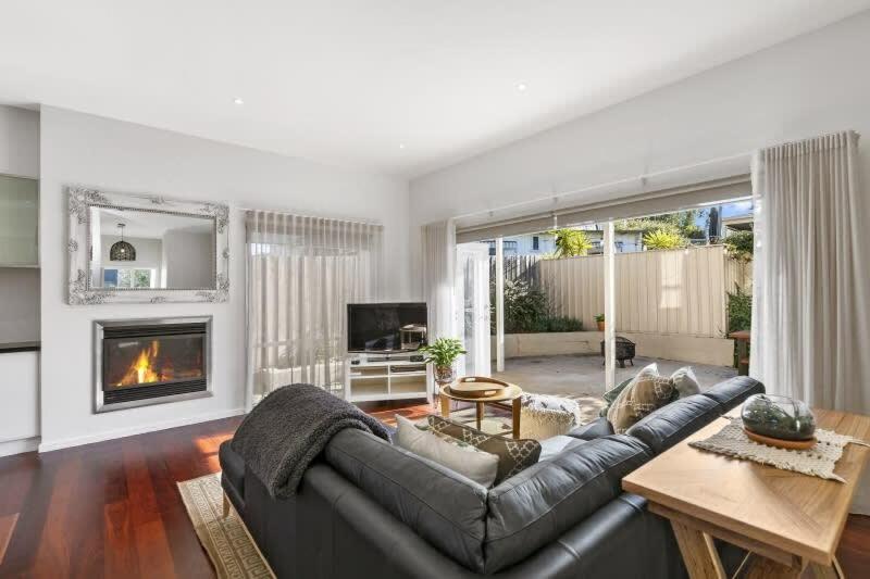 a living room with a couch and a fireplace at The Briars 450m to Torquay Front Beach in Torquay