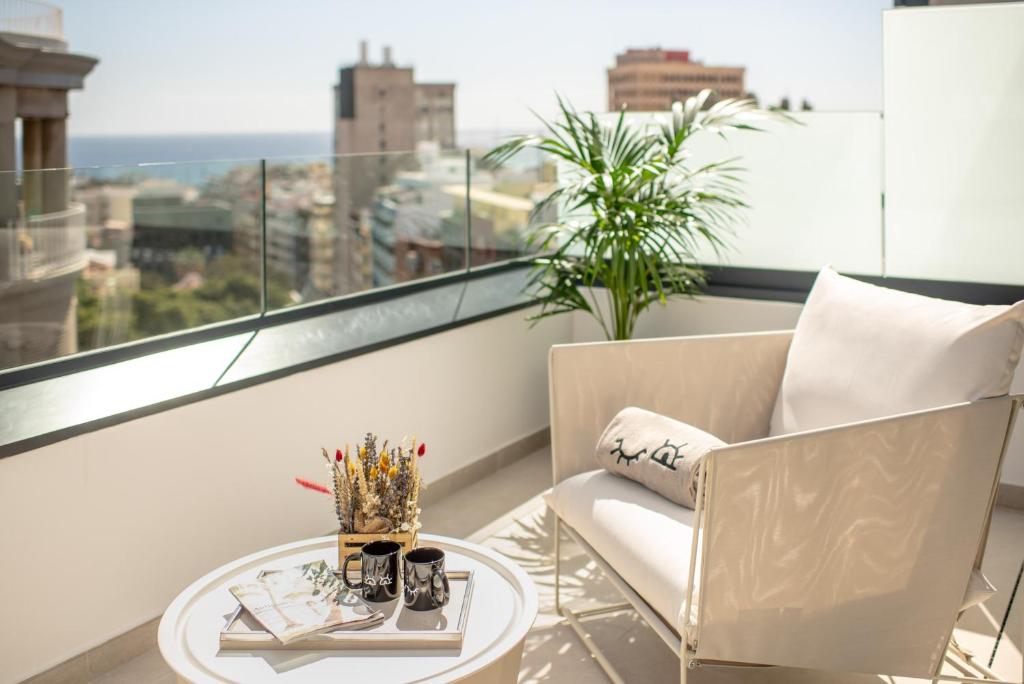 a room with a chair and a table and a window at INNSiDE by Meliá Tenerife Santa Cruz in Santa Cruz de Tenerife