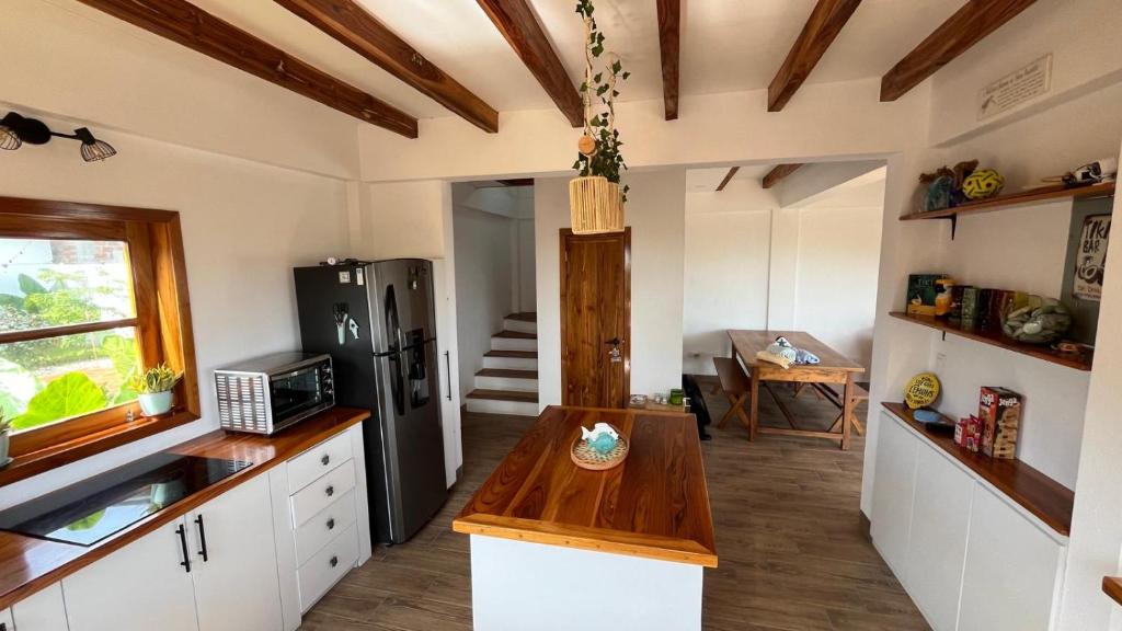 a kitchen with a refrigerator and a table in it at Villas del Mar in Las Tunas