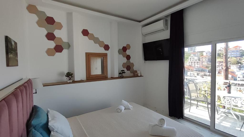 a bedroom with a bed and a large window at Wave Sound Apartments - Village View in Skala Marion