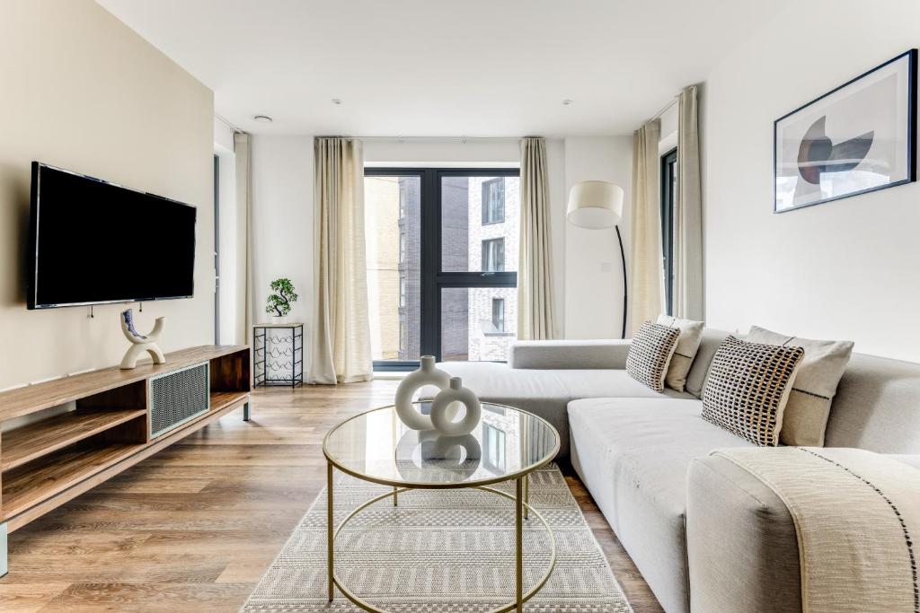 un soggiorno con divano e TV di The Wandsworth Luxury Apartment a Londra