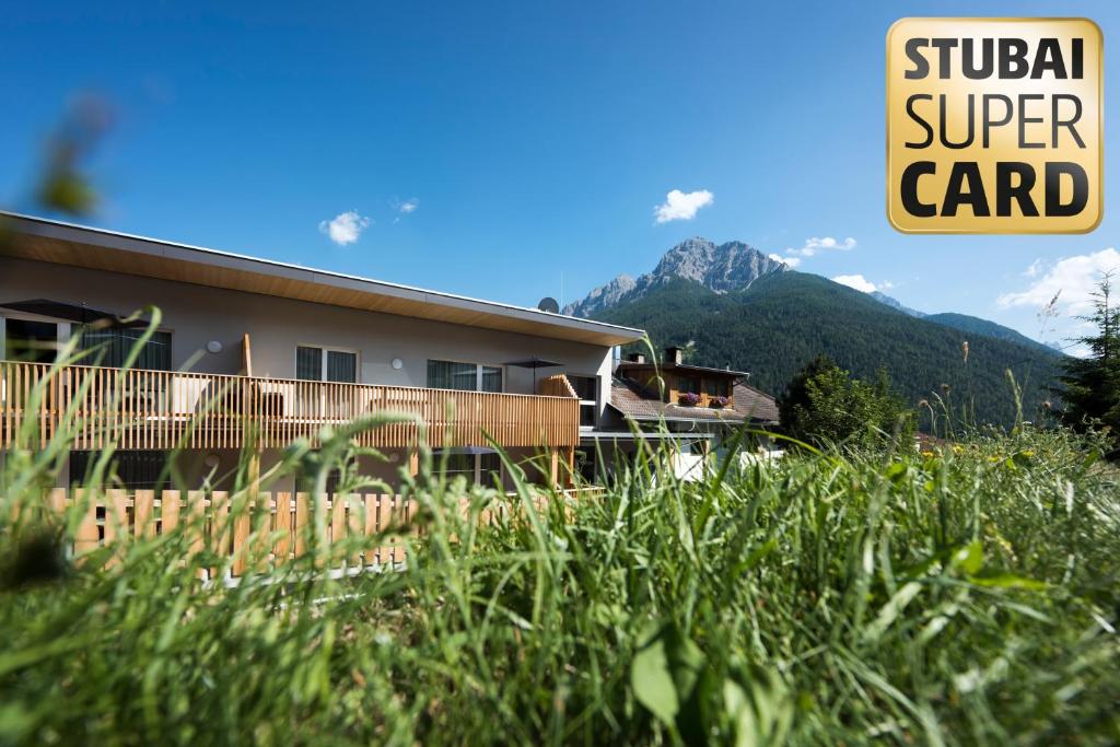 a building with a sign that reads global super card at Appartements an der Kaburga in Telfes im Stubai