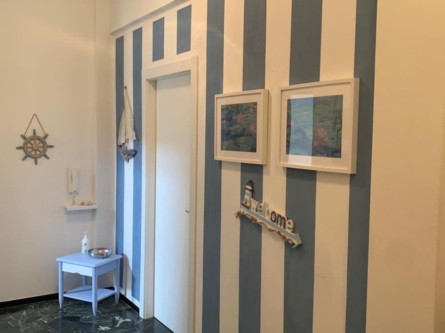 a hallway with a striped wall with a door at SpazioSanta in Santa Margherita Ligure