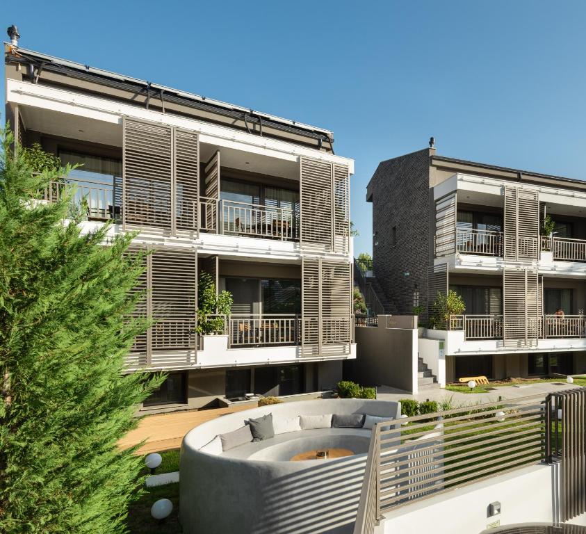 an apartment building with a hot tub in the courtyard at Eco Green Residences & Suites in Toroni