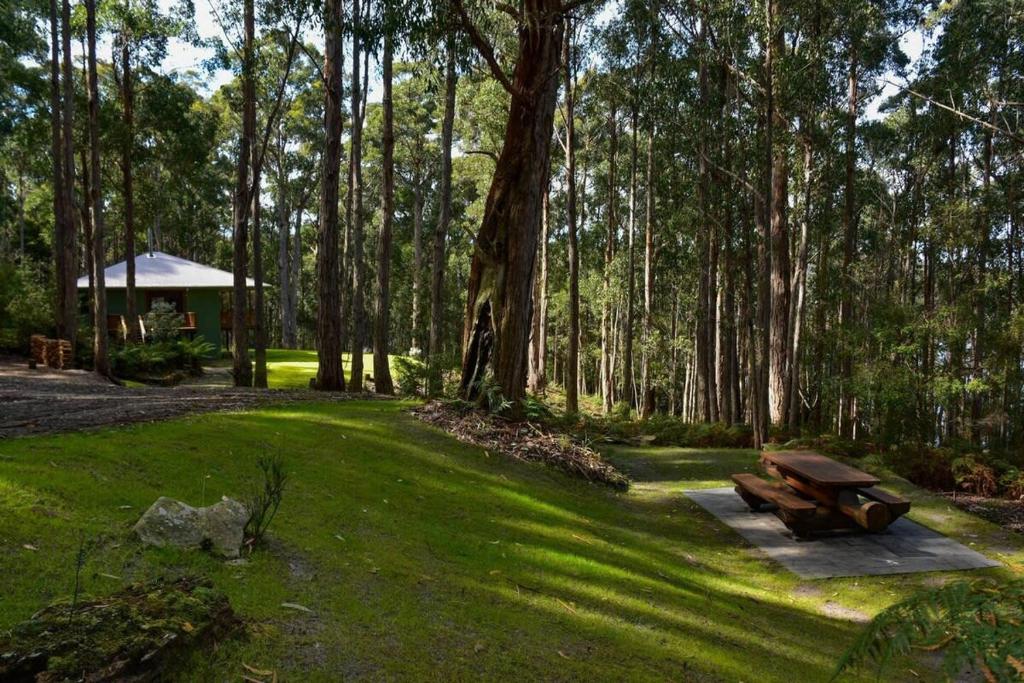 a park with a picnic bench in the grass at Hastings Bay Retreat in Hastings