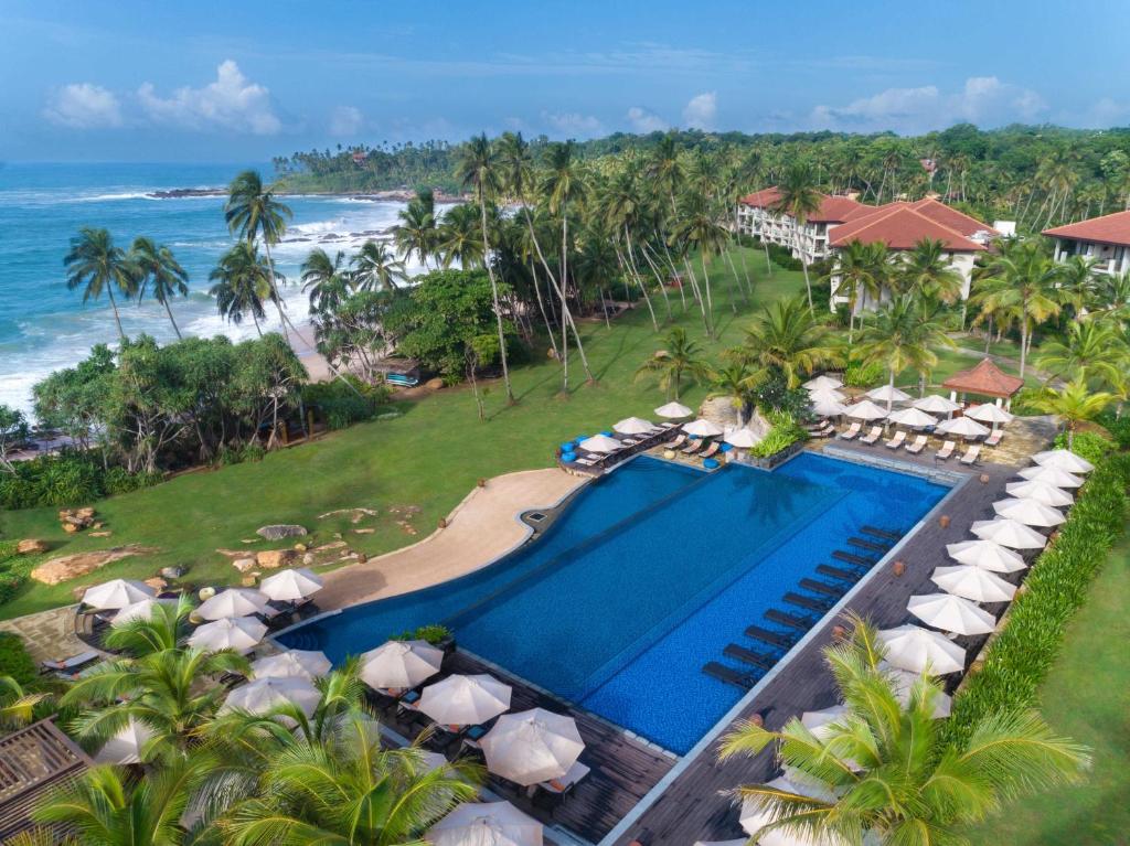 an aerial view of a resort with a swimming pool and the ocean at Anantara Peace Haven Tangalle Resort in Tangalle