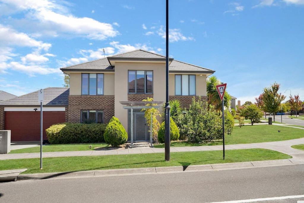 a house on the side of a street with a street sign at Deluxe Family Montpellier Gardens Estate - Burwood in Burwood