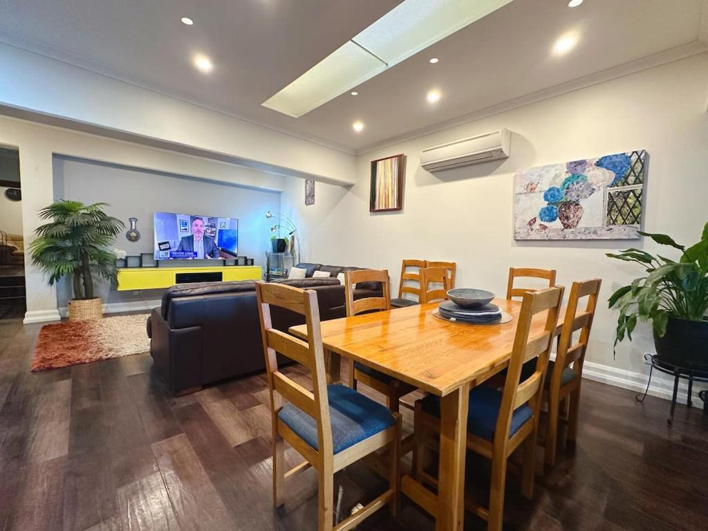 a dining room with a wooden table and chairs at Heritage Building Penthouse CBD Apartment in Hobart