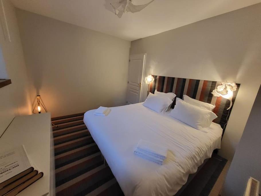 En eller flere senge i et værelse på Appartement avec terrasse