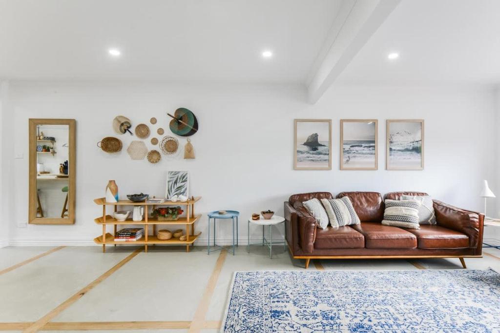 a living room with a brown leather couch and a rug at Rye Getaway - Well Appointed & Cozy Family Home* in Rye