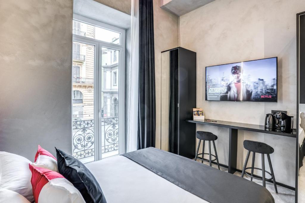 a hotel room with a bed and a window at Gallery Experience Napoli in Naples