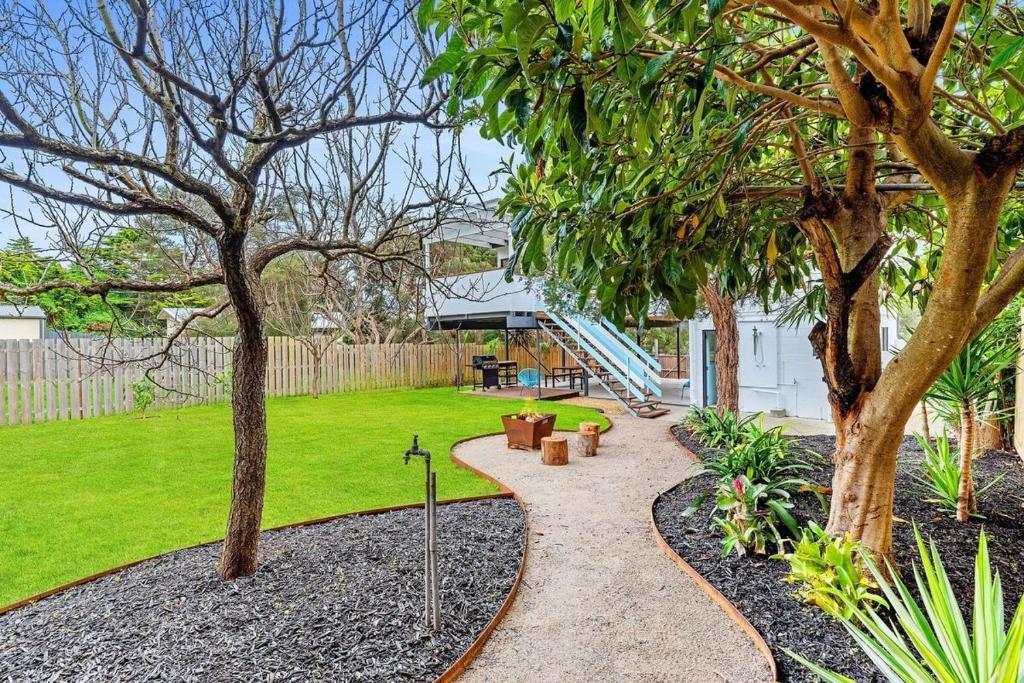 a garden with a walkway between two trees at Premiere Seaside Home - Relaxing Family Getaway* in Rye