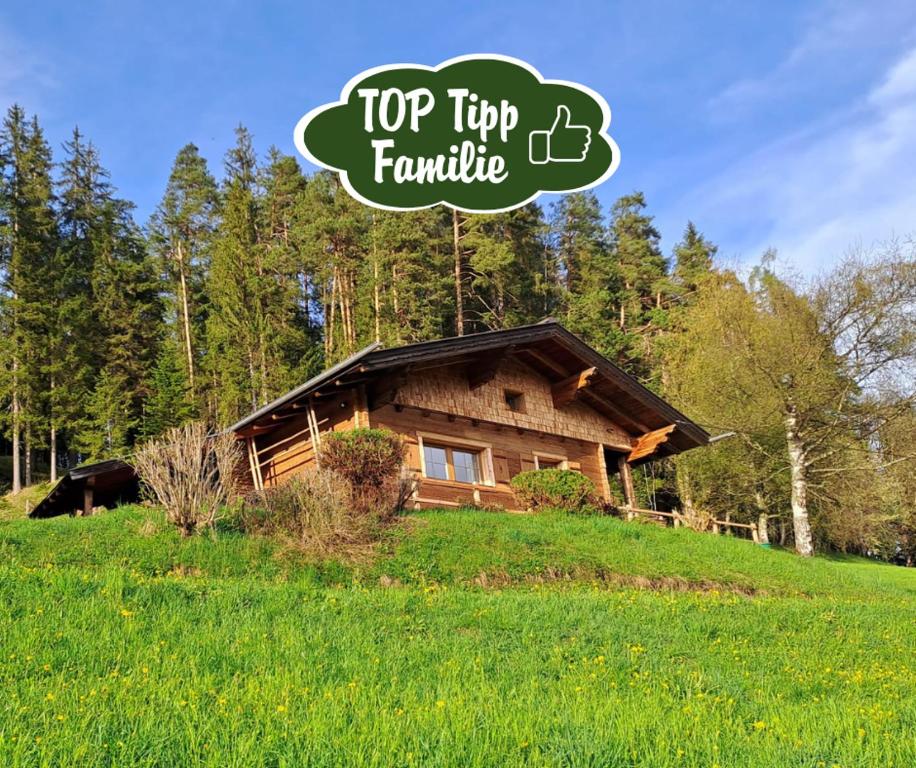 a log cabin on a hill with the top tip famille logo at Almliesl ALTZ-718 in Altenmarkt im Pongau