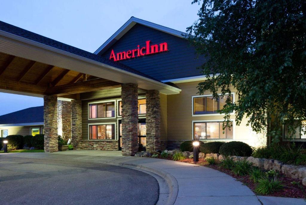 a american inn with a sign on the front of it at AmericInn by Wyndham Shakopee Near Canterbury Park in Shakopee