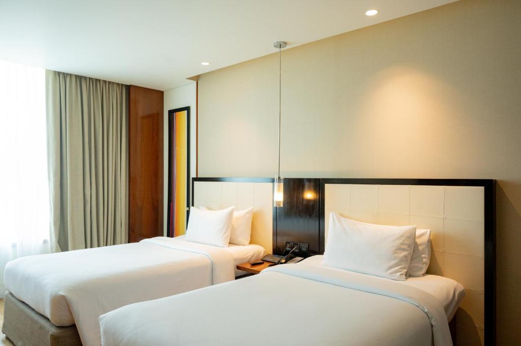 Postel nebo postele na pokoji v ubytování DoubleTree by Hilton-Pune Chinchwad