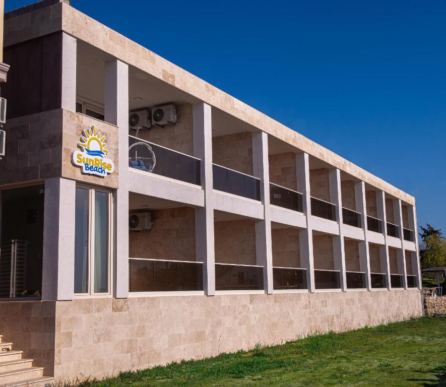 a building with a sign on the side of it at SunRise Beach in Venus
