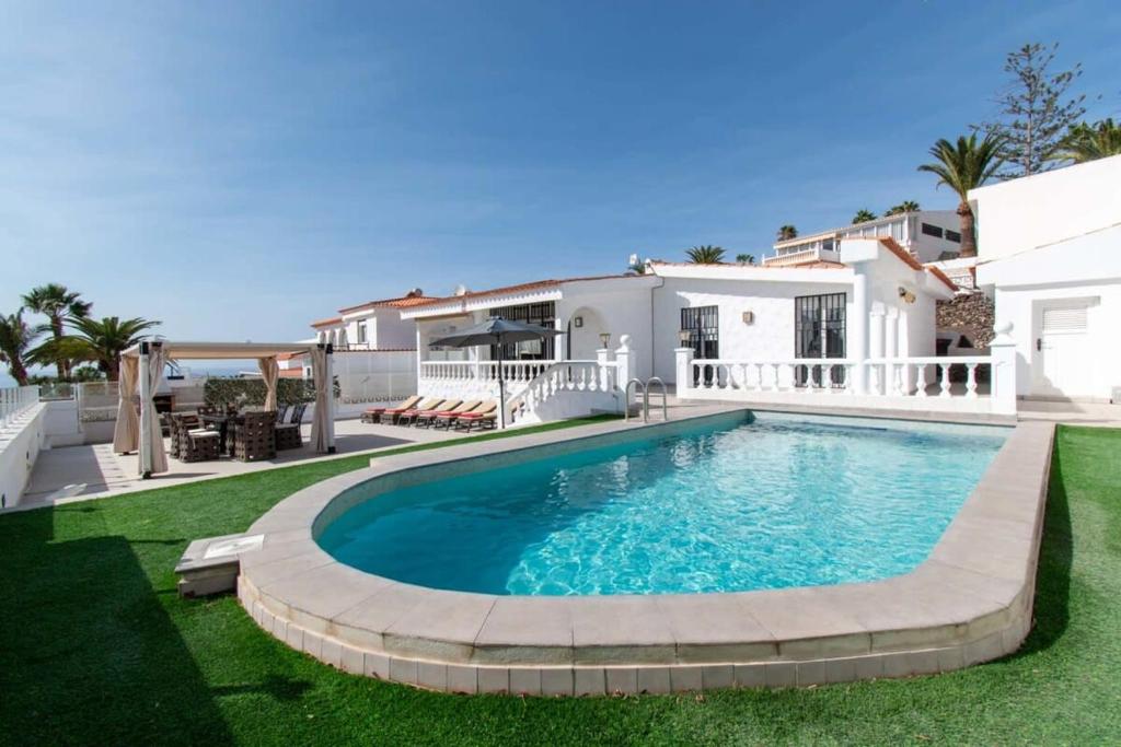 a swimming pool in the backyard of a house at Villa Melua in Chayofa