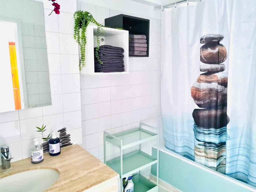 a bathroom with a sink and a shower curtain at Bella Vista / Appartement vue mer in Nice