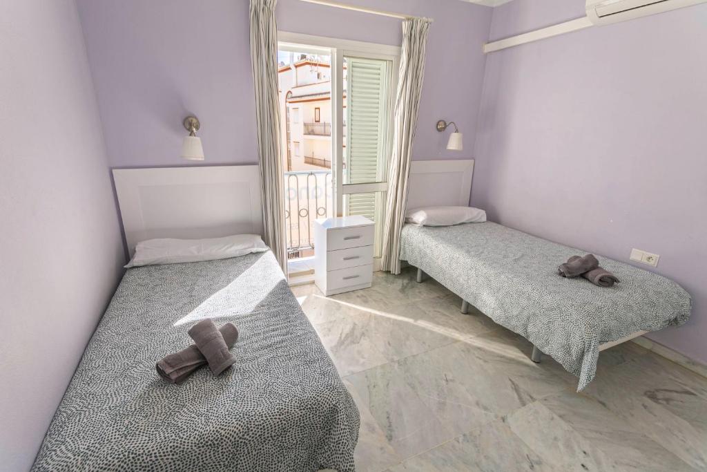dwa łóżka w pokoju z dwoma misiami na nich w obiekcie Canovas Nerja - Casa adosada con piscina Los Huertos 6 w mieście Nerja