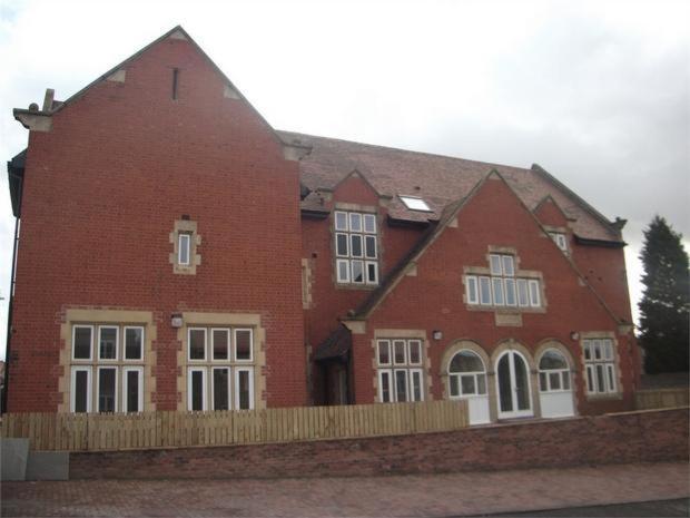 a large red brick building with white windows at Whitwell in Worksop