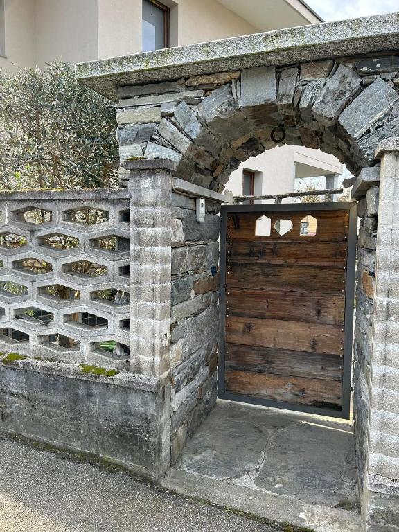 a wooden garage door in a stone wall at Casa Dolce Casa in Masera
