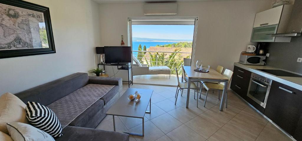 a living room with a couch and a table at Apartman Doris in Dramalj