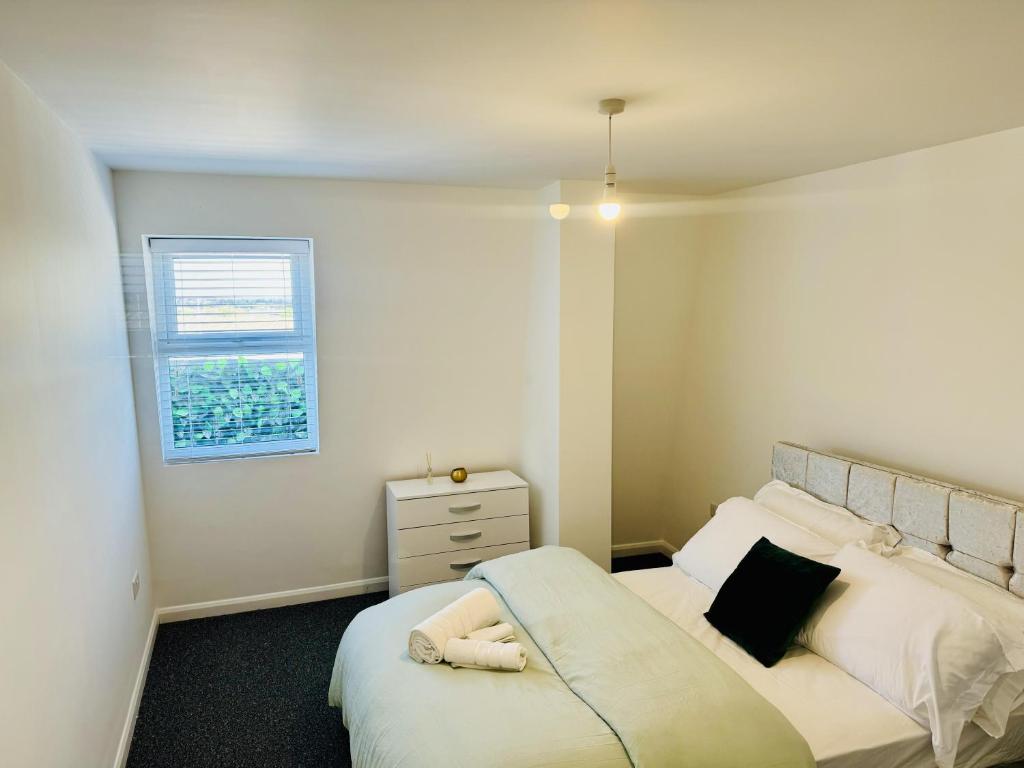 a small bedroom with a bed and a window at A unique spacious 2-Bed Apartment in North London in London
