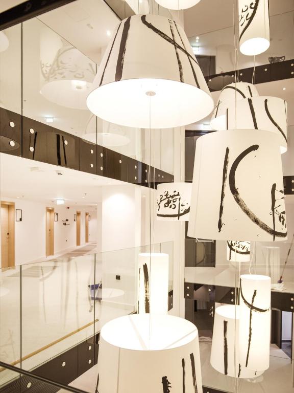 a store with white tables and chandeliers at Hotel Kompas in Dubrovnik