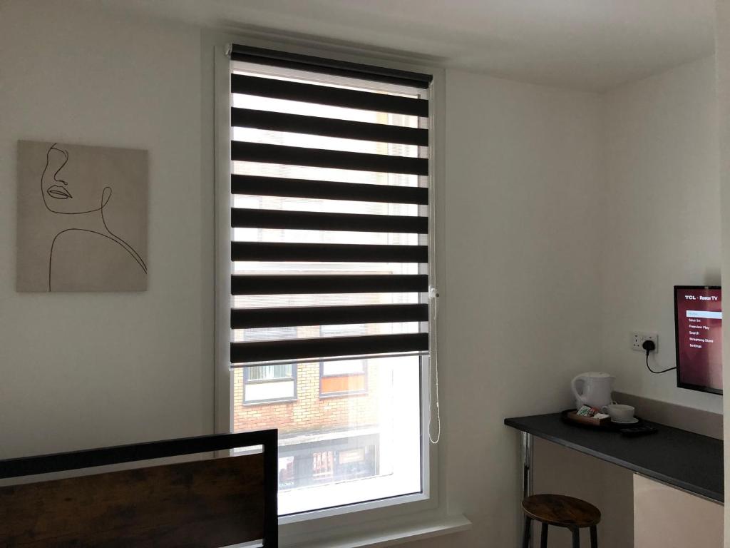 a room with a window with a window blind at Studio in Bolton town, Short stay studio 3, in Bolton