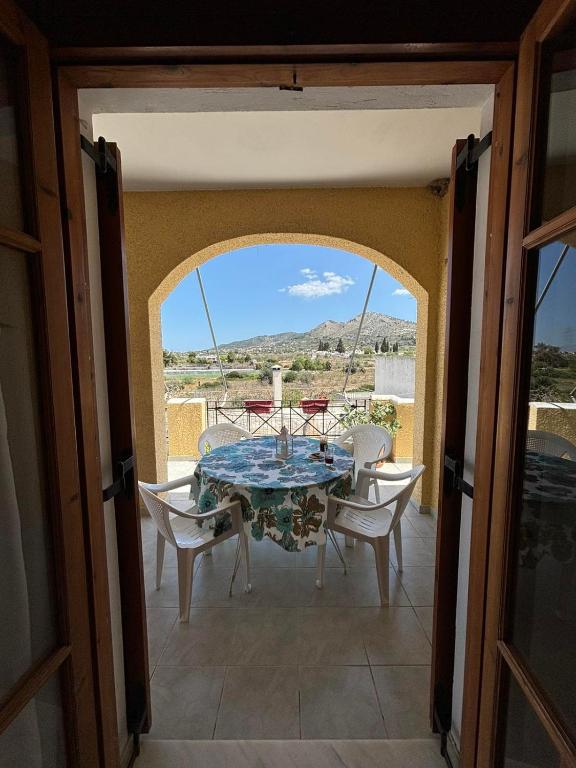 a dining room with a table and chairs on a balcony at Christina's house in Kipséli