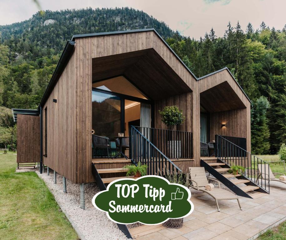 a tiny house with a top tip sign in front of it at Almliesl UNKE-684 in Unken