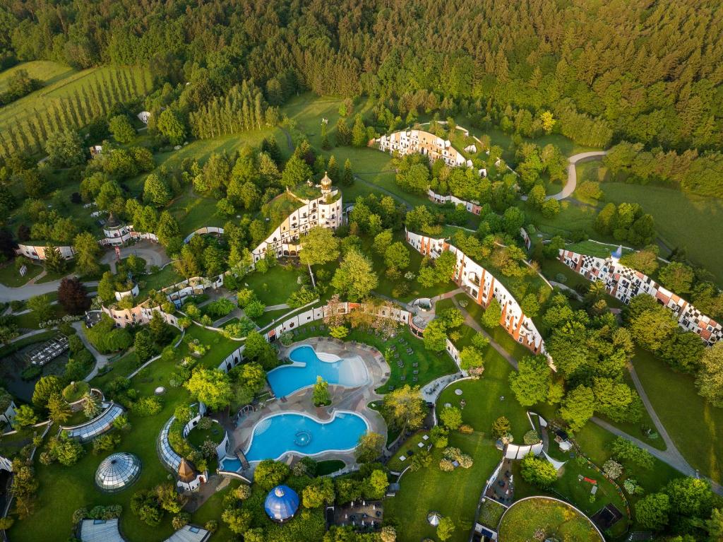 an aerial view of a park with a resort at Rogner Bad Blumau in Bad Blumau