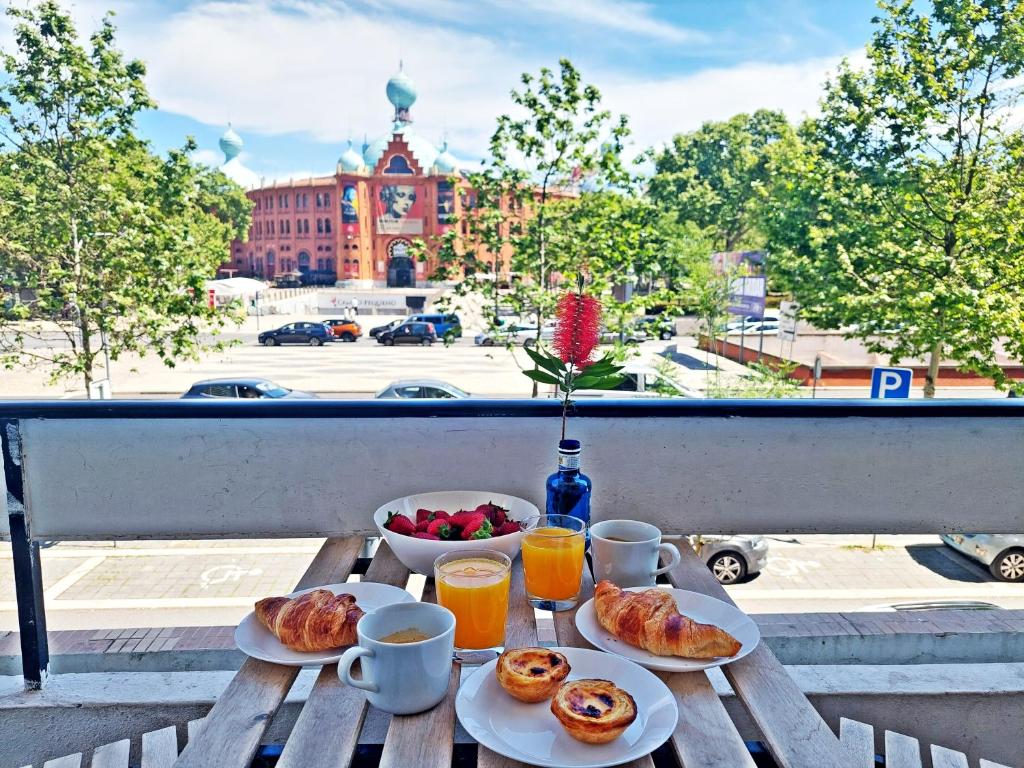 a table with breakfast foods and drinks on a balcony at Obrigado Lisboa in Lisbon