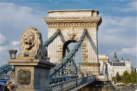 a bridge with a lion on top of it at Peaceland Apartment Budapest in Budapest