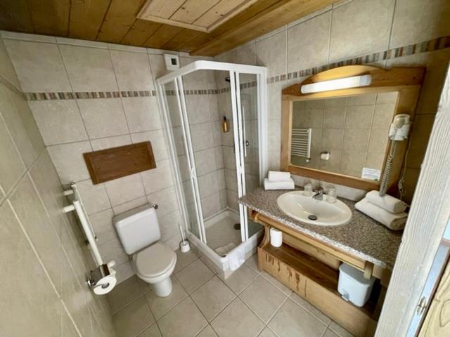 a bathroom with a shower and a toilet and a sink at Le Vancouver in La Plagne