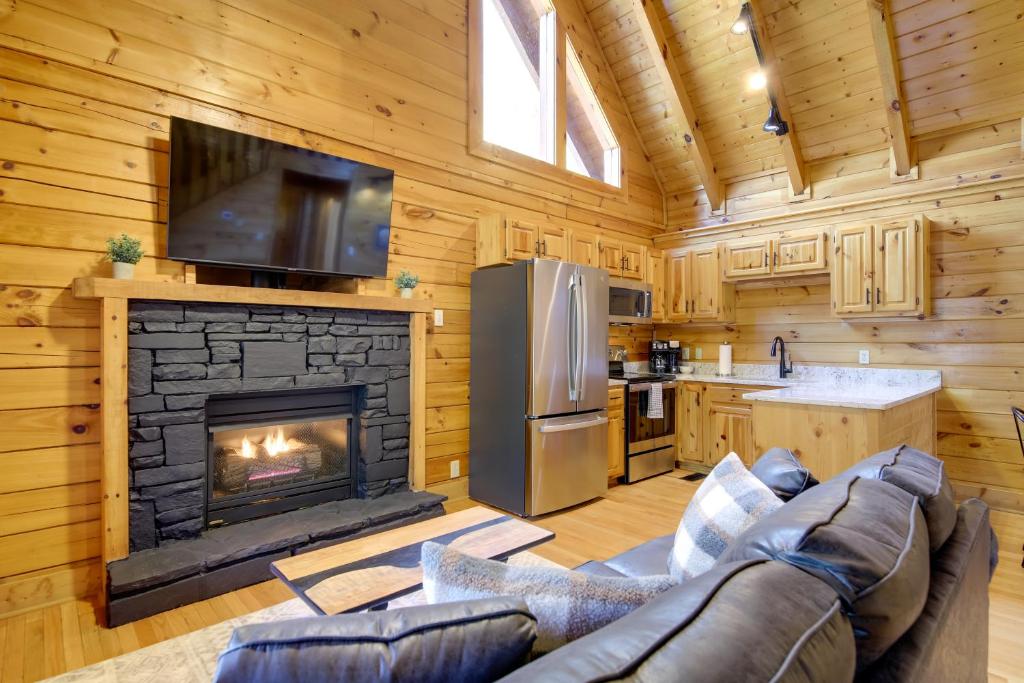 a living room with a couch and a fireplace at Pigeon Forge Vacation Rental with Private Hot Tub! in Pigeon Forge