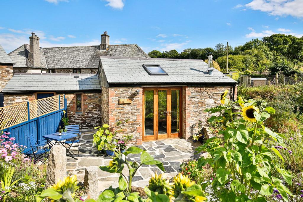 a stone house with a patio in front of it at Cornwall cottage The Old Piggery in Liskeard