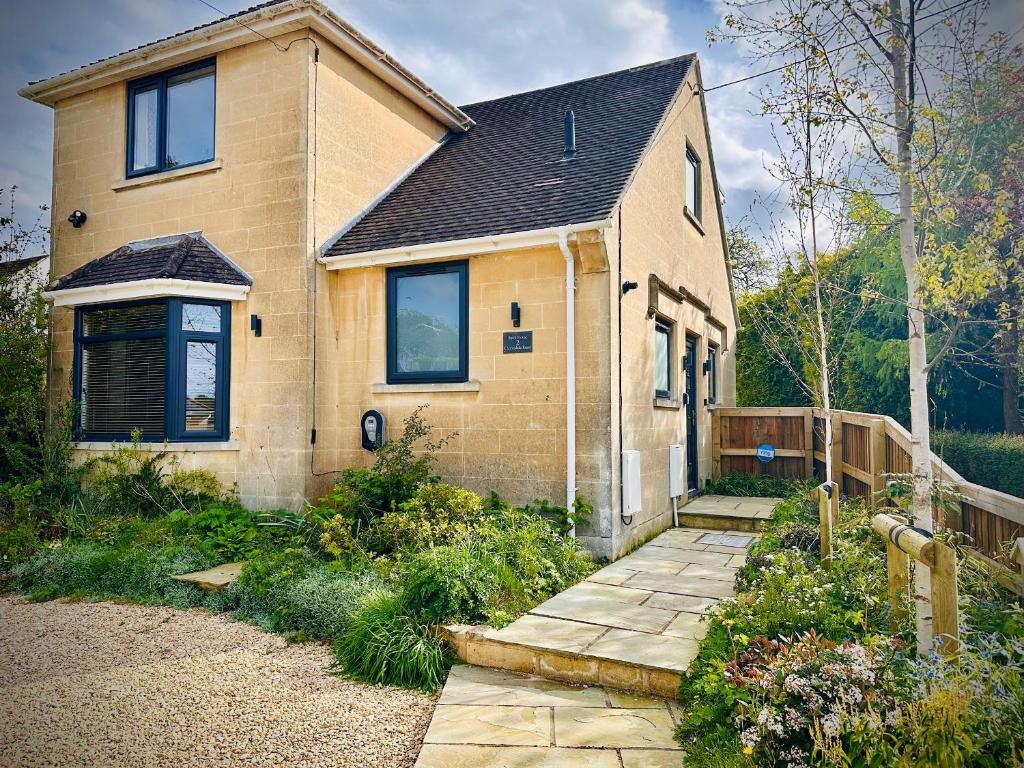 a brick house with a pathway in front of it at Birch House in Corsham