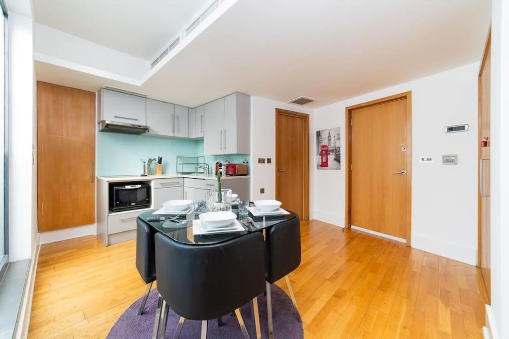 a kitchen with a table and chairs in a room at Piccadilly Circus-West End Central London Studio Apartment in London