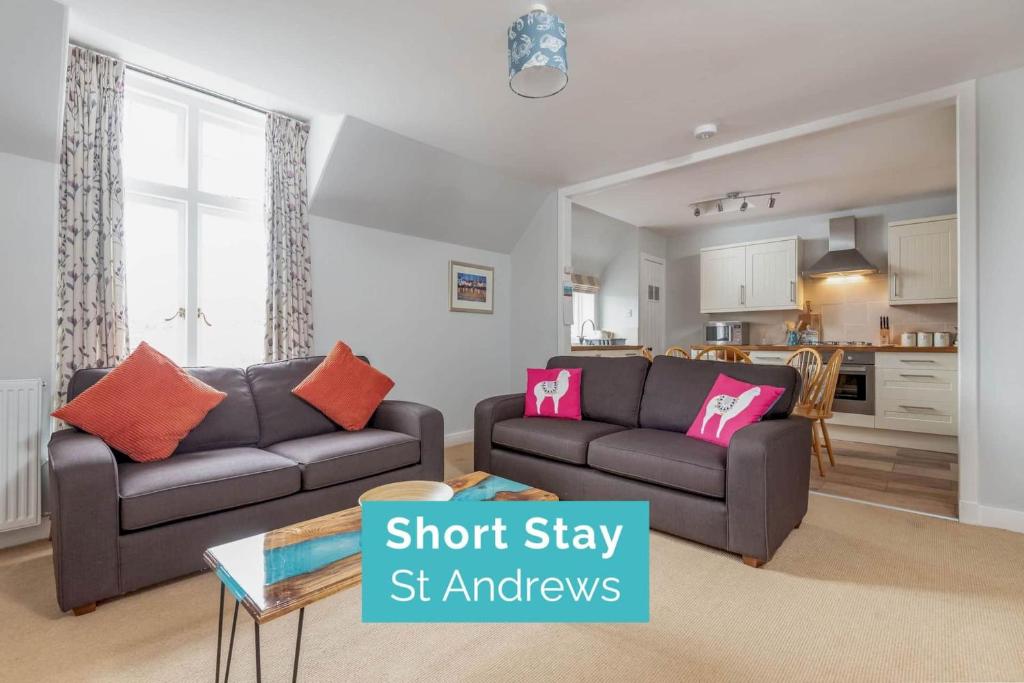 a living room with two couches and a kitchen at The Stables Loft, Close to Elie Beach in Elie