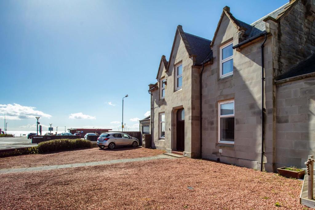 a car parked in front of a house at South Beach View in Troon